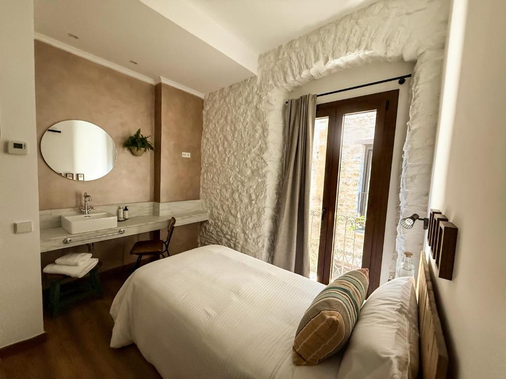 En eller flere senge i et værelse på UMA Rural Boutique