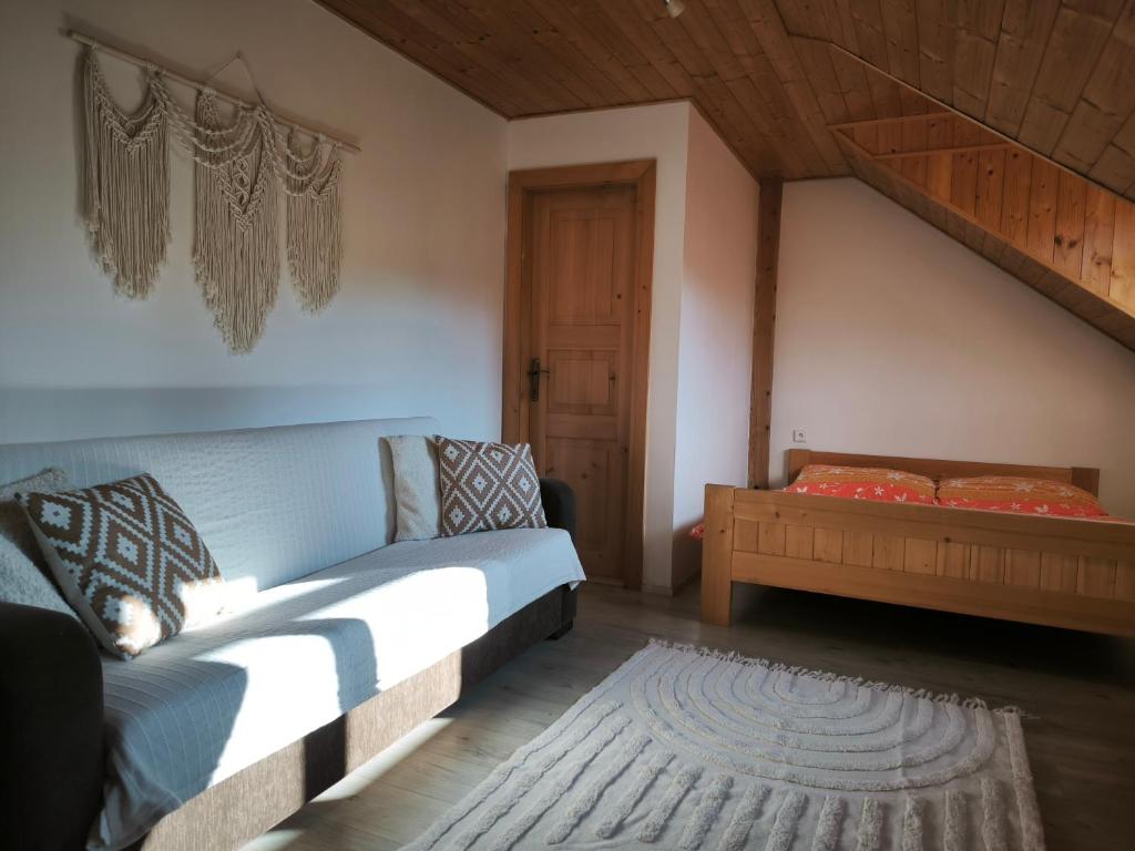 a bedroom with a bed and a stair case at Penzion Pod Chřiby in Zdounky