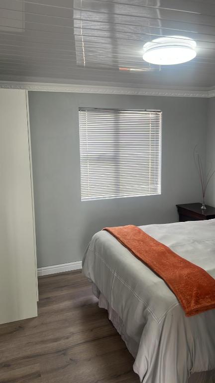a bedroom with a large bed and a window at Oryx guest house in Oakdale