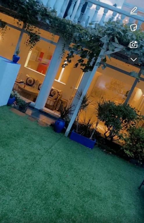 a large building with plants in a yard at majorelle in Brussels