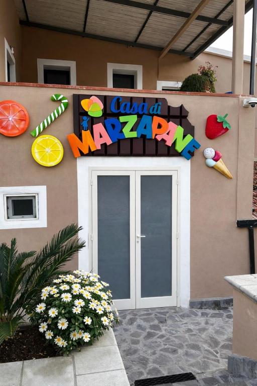 a building with a sign that says dad at may at La casa di Marzapane in Spigno Saturnia
