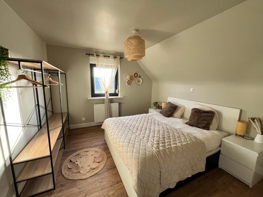 a bedroom with a large bed and a window at Casa Loua in Blankenberge