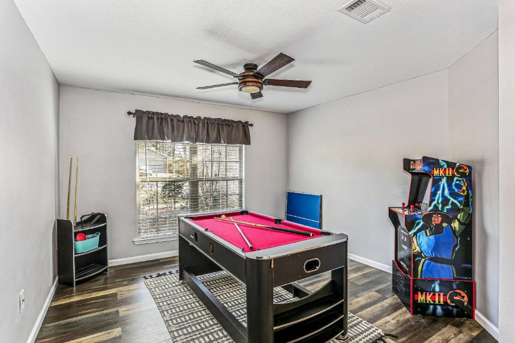 a room with a pool table and arcade games at 1973 Salamanca St in Navarre