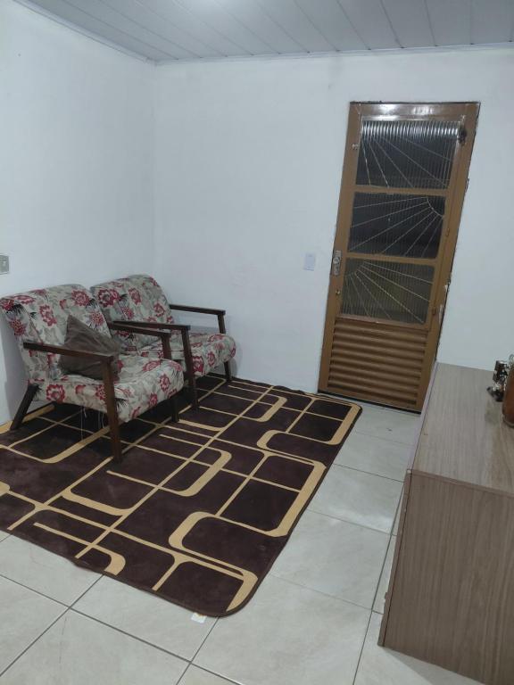 a living room with a couch and a door at Pousada do Coqueiro in São Gabriel