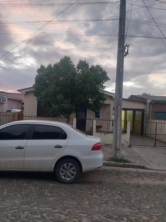 a white car parked on the side of a street at Casa do Fernando in São Gabriel