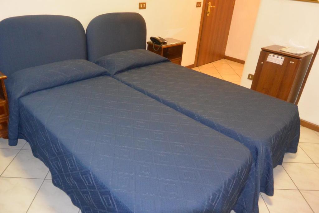 Postel nebo postele na pokoji v ubytování Hotel Italia City Center