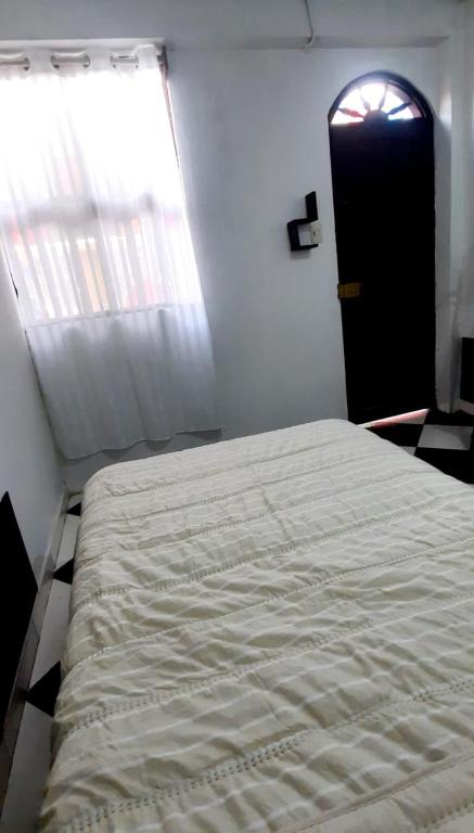 a bedroom with a large bed and a window at Sunset bed in Puerto Chicama