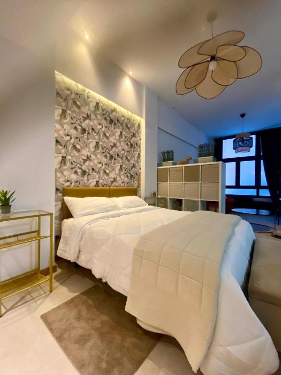 a bedroom with a large white bed and a ceiling at Castro Romano VUT 7712 AS in Gijón