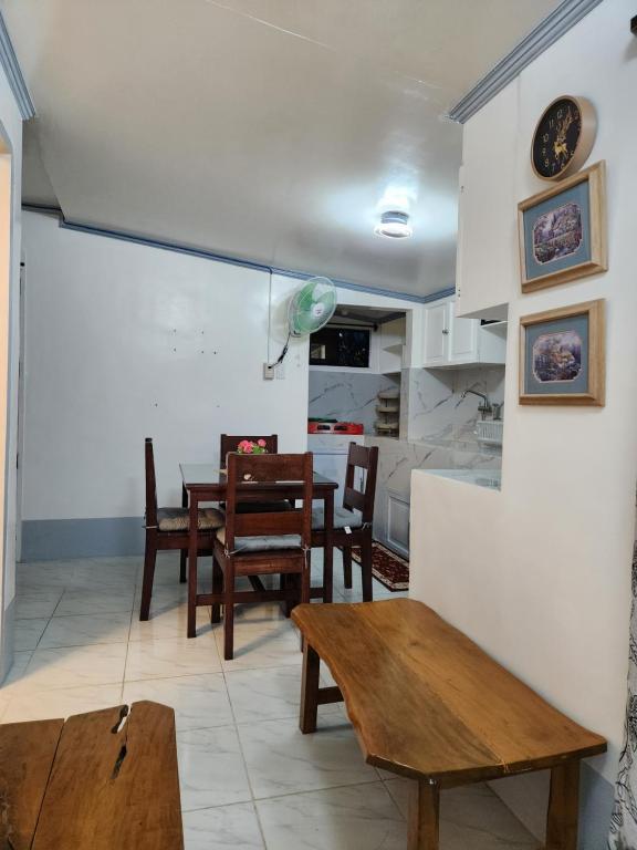a living room with a table and a dining room at Teachers Home in Panong