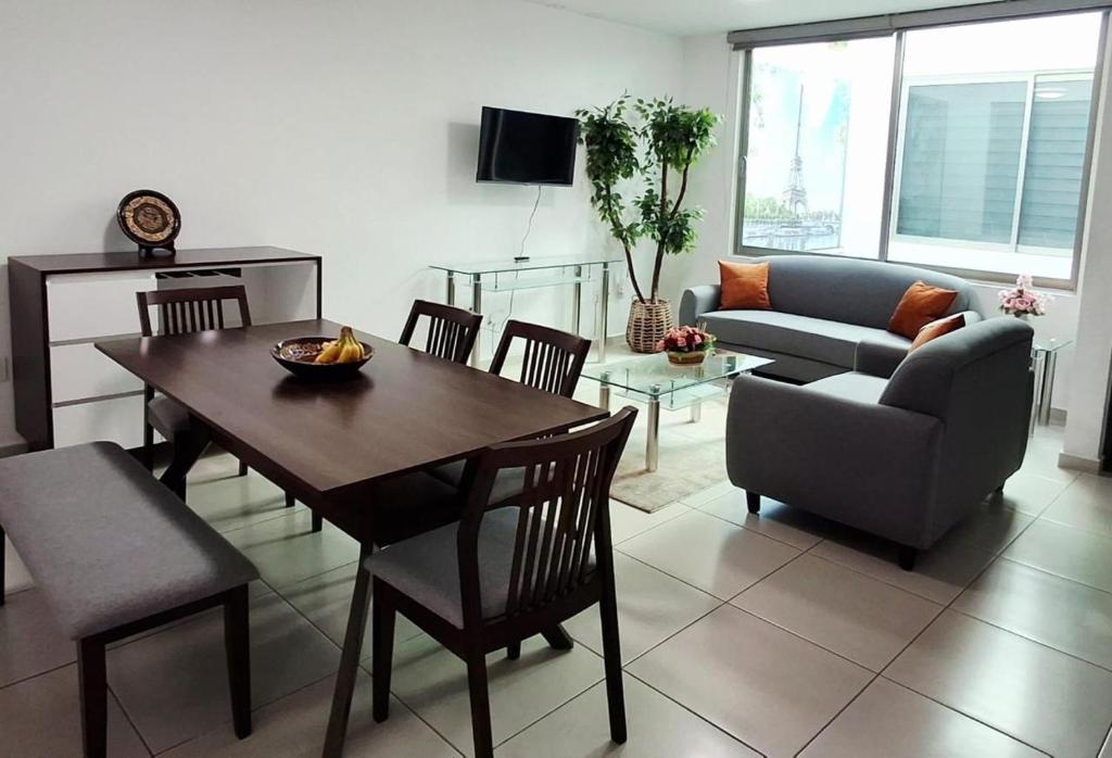 a living room with a table and chairs and a couch at Cielito Lindo in Uruapan del Progreso