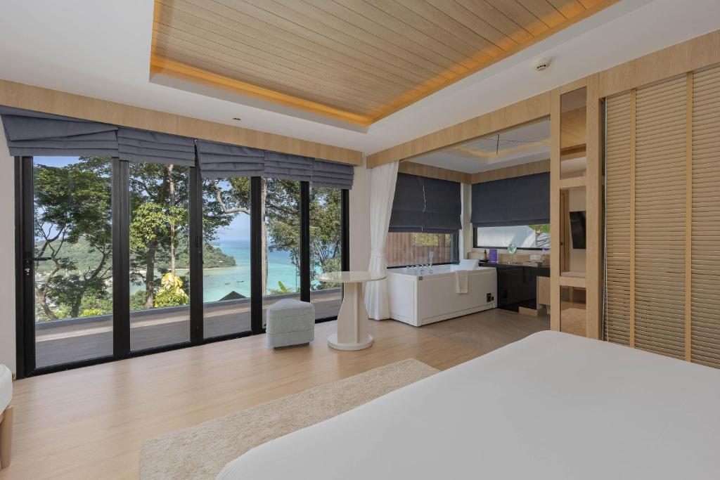 a bedroom with a view of the ocean at Centara Villas Phi Phi Island in Phi Phi Don