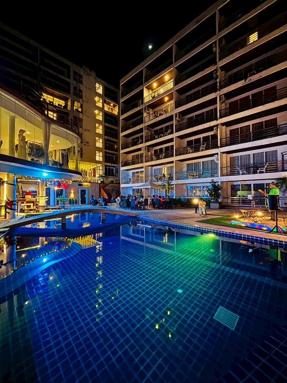 a large swimming pool in a building at night at Ocean View Treasure Residence in Patong Beach