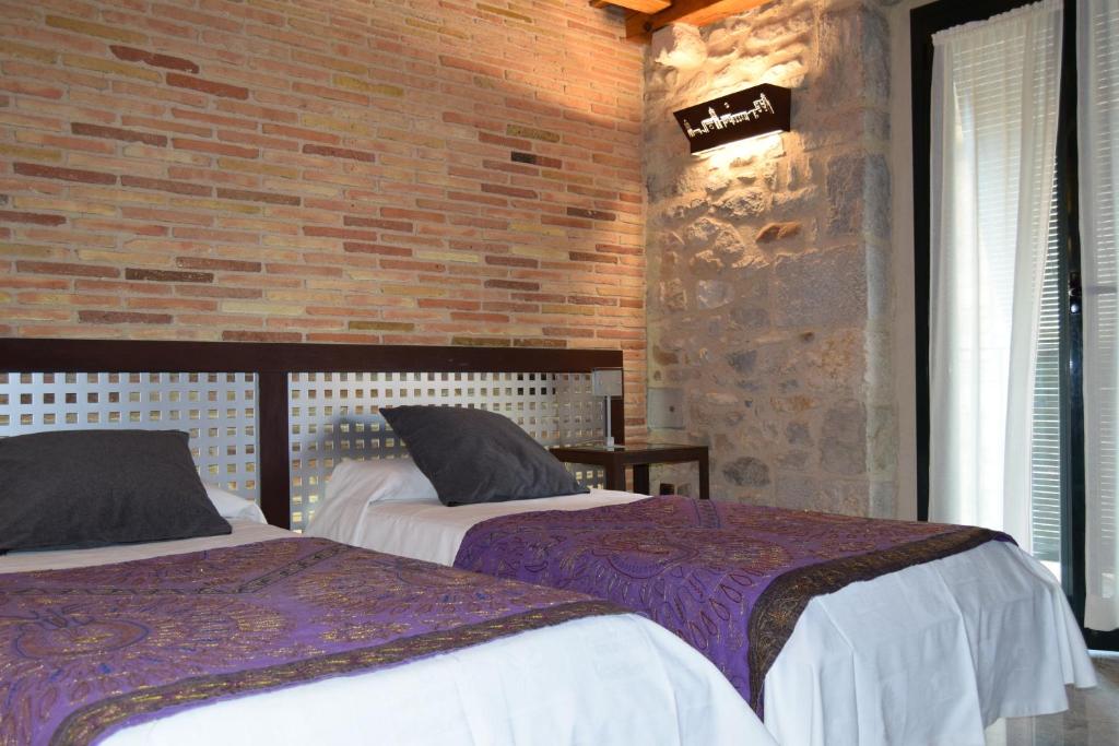 Postel nebo postele na pokoji v ubytování Hotel Històric