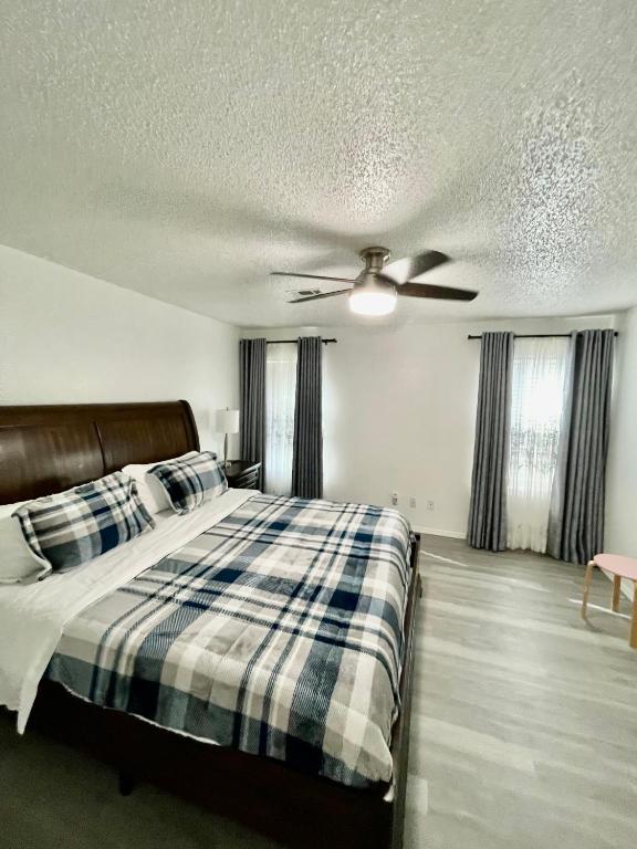a bedroom with a bed and a ceiling fan at Emmanuel House in Tulsa