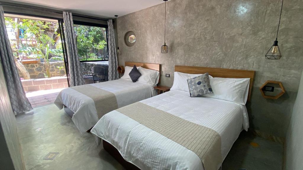 En eller flere senge i et værelse på Hotel Casa Grangelo