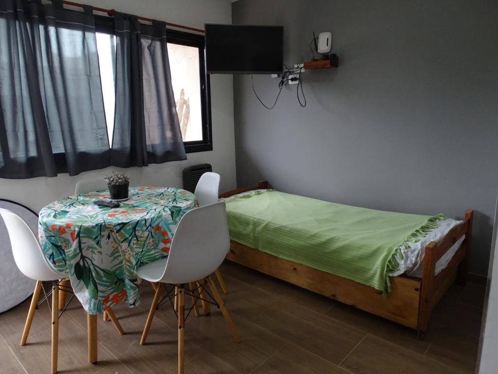 una camera da letto con un letto, un tavolo e delle sedie di El gran nogal colon a Colón