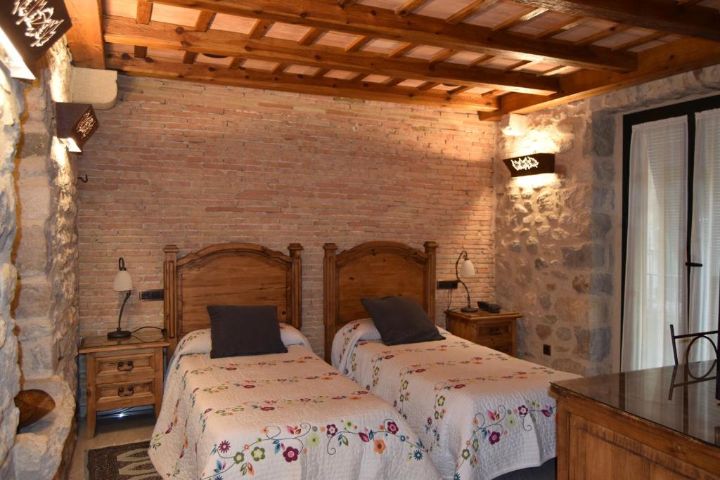 Postel nebo postele na pokoji v ubytování Hotel Històric