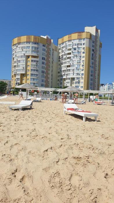 a beach with benches and buildings in the background at Видові апартаменти на пляжі in Cherkasy