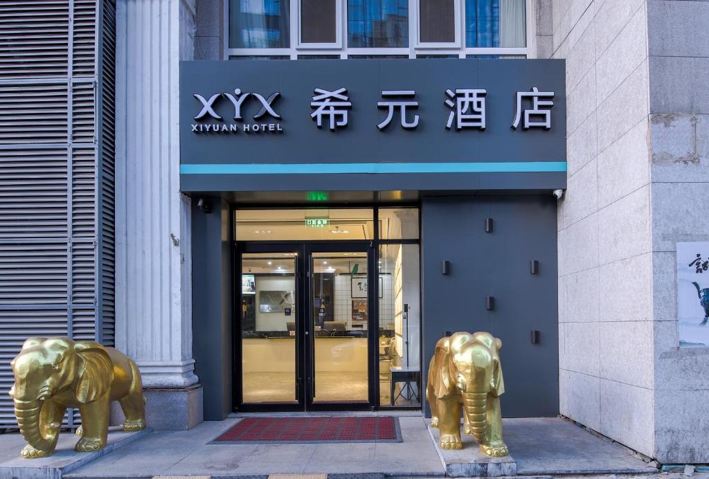 two gold elephants in front of a building at WangfujingXiyuanHotel Central Beijing in Beijing