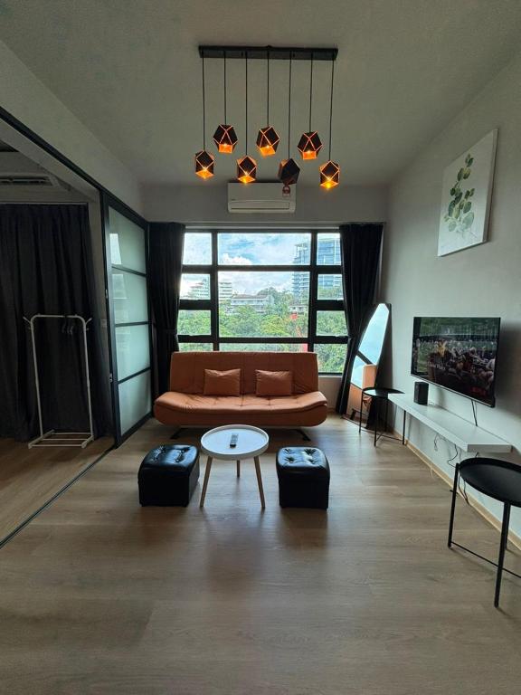 a living room with a couch and a table at Jesselton Quay by SNUG SPACE in Kota Kinabalu