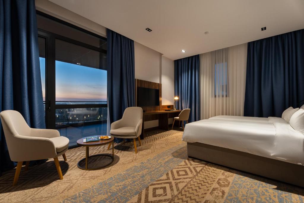 a hotel room with a bed and a desk at Qashqadaryo Hotel Olympic Village in Tashkent
