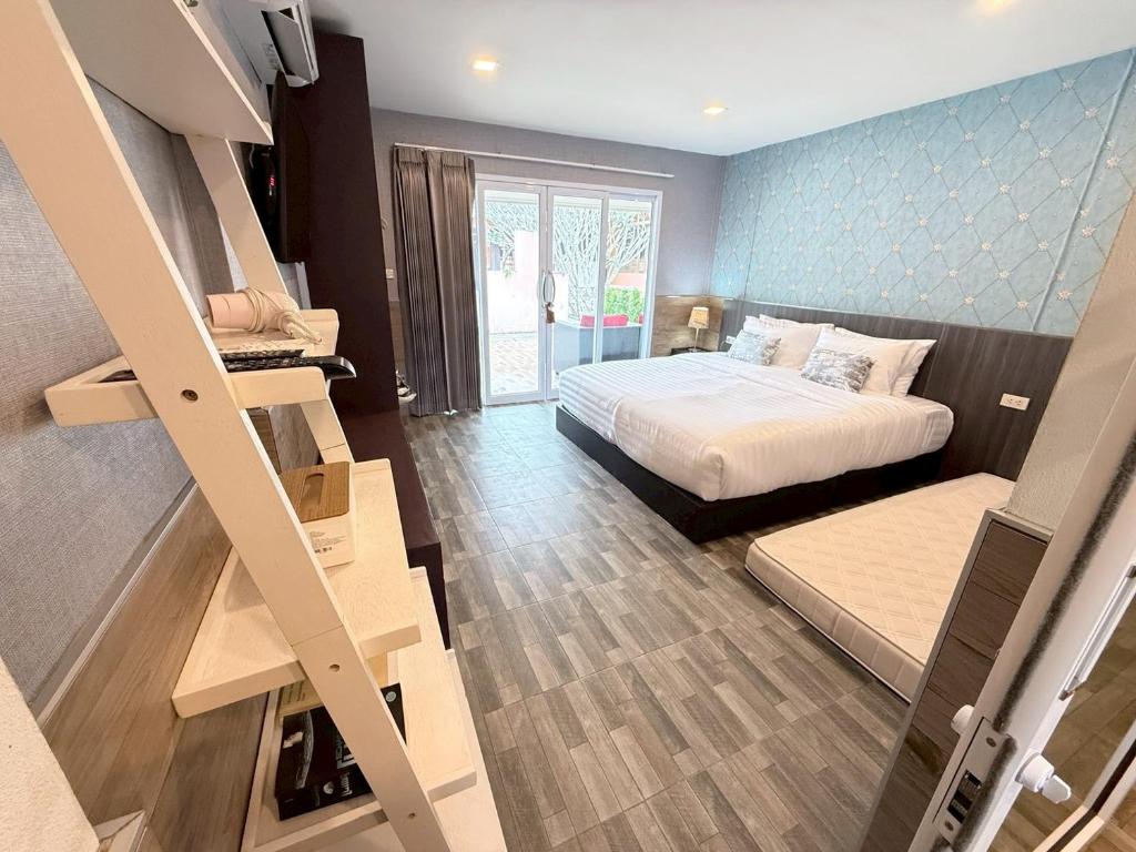 a small bedroom with a bed and a staircase at All Times Pool Villas in Ban Tha Khun