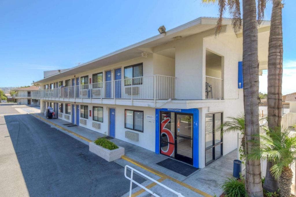 a building with palm trees in front of it at Motel 6-San Ysidro, CA - San Diego - Border in San Ysidro