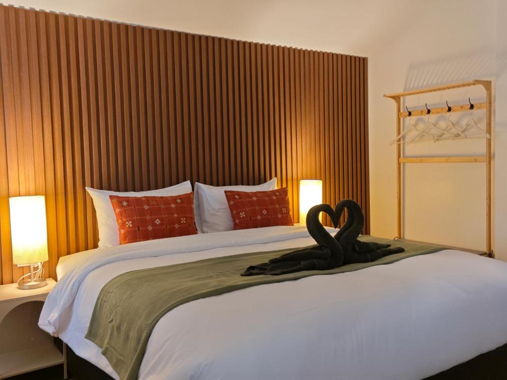a bedroom with a large bed with swans on it at Tangerine Villa Patong in Patong Beach