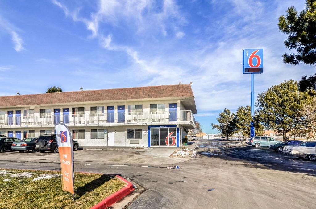 a person standing in front of a building at Motel 6-Fort Collins, CO in Fort Collins