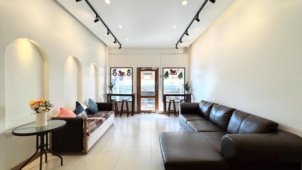 a living room with a couch and a table at MaMa Hostel CNX in Chiang Mai