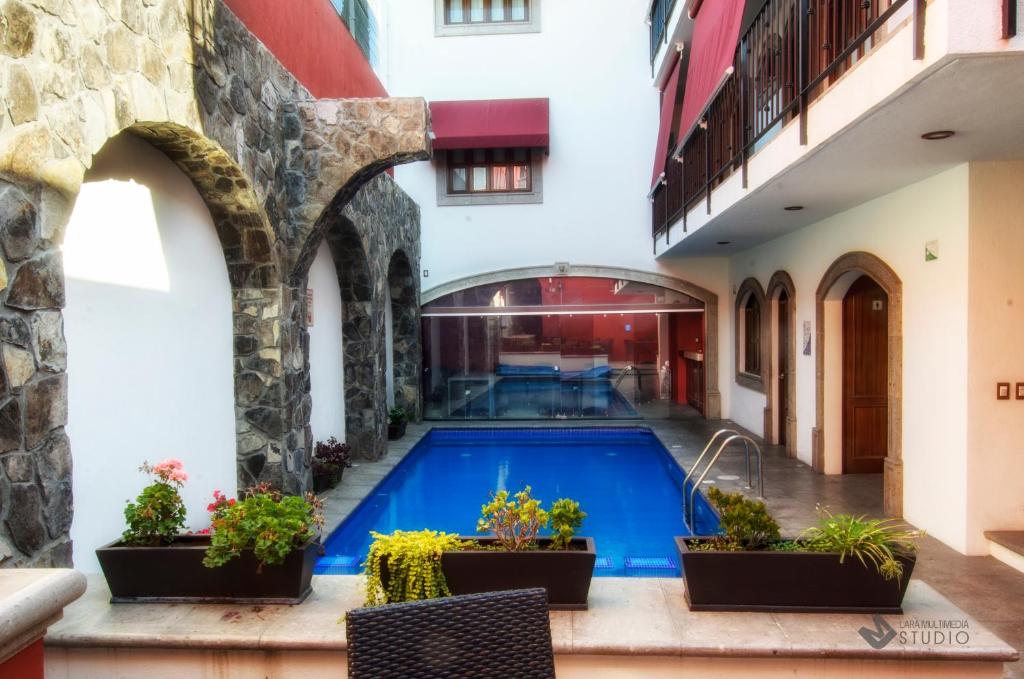 a swimming pool in the middle of a building at Hotel San Xavier in Querétaro