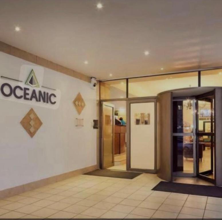 einen Eingang zu einem Laden mit einem Schild an der Wand in der Unterkunft Durban Oceanic 82B in Durban