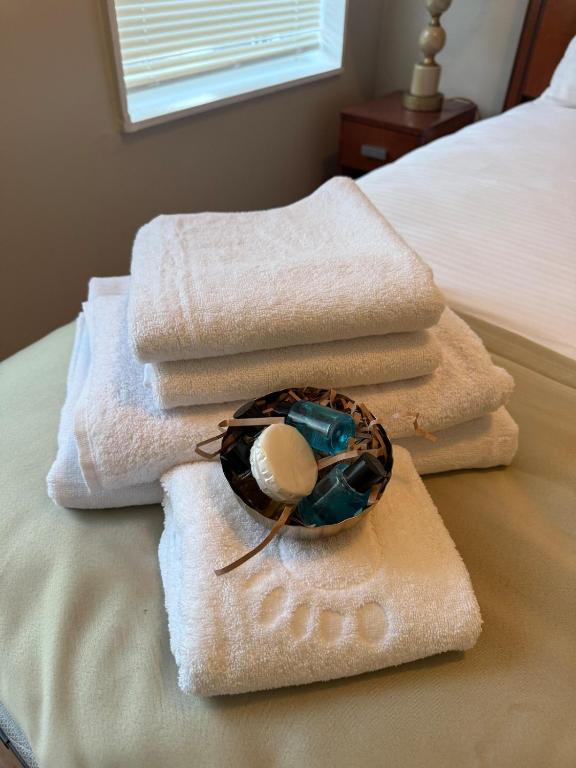 a pile of towels sitting on top of a bed at Eagle Pamir Guest House in New Haven