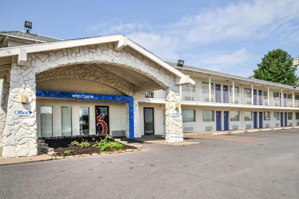 a large white building with an arch in front of it at Motel 6-Saint Joseph, MO in Saint Joseph