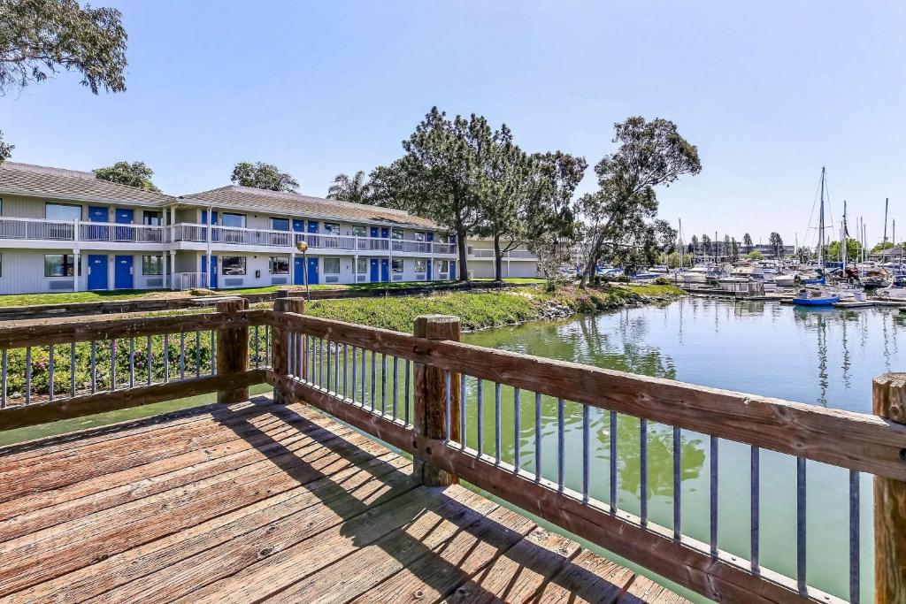 a dock with a building and a marina at Motel 6-Oakland, CA - Embarcadero in Oakland