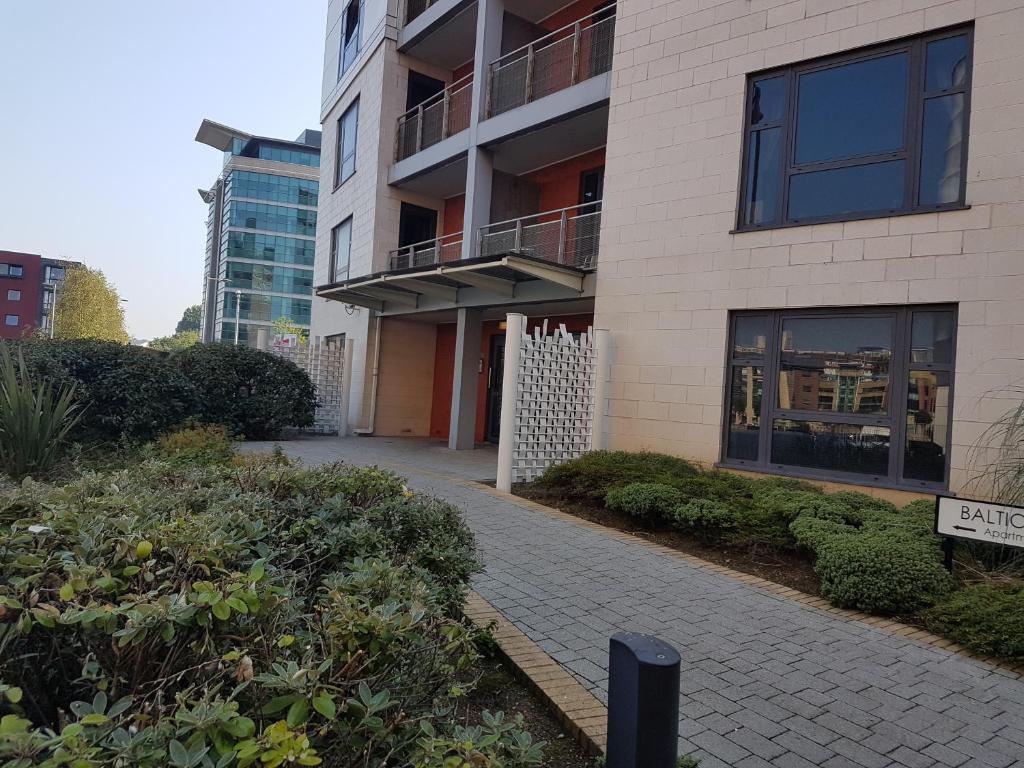 a building with a walkway in front of it at Baltic Quays Newcastle Upon Tyne in Newcastle upon Tyne