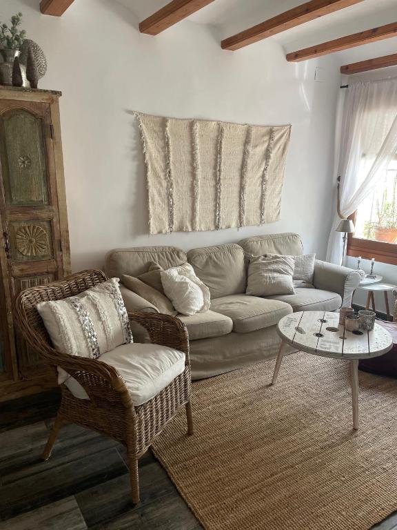 a living room with a couch and a table at Cozy Townhouse Altea in Altea