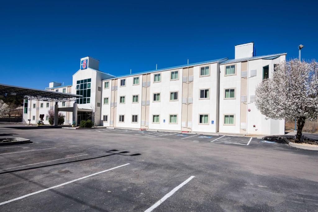 duży biały budynek z parkingiem w obiekcie Motel 6-Ruidoso, NM w mieście Ruidoso