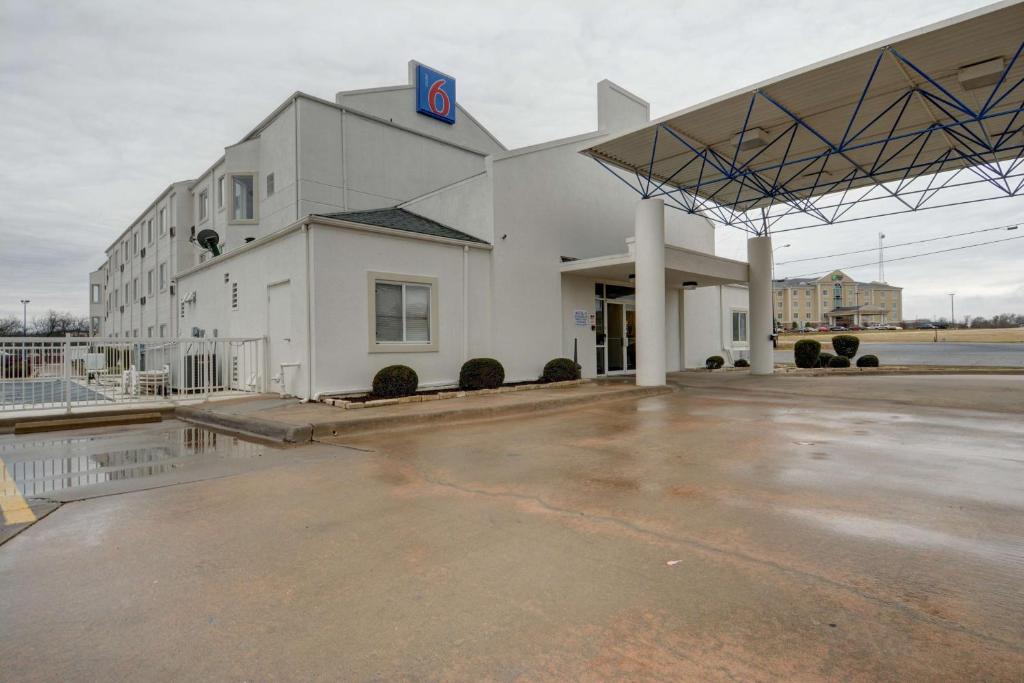a large white building with a number on it at Motel 6-Denison, TX in Denison