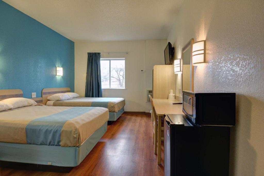 a hotel room with two beds and a television at Motel 6-Denison, TX in Denison