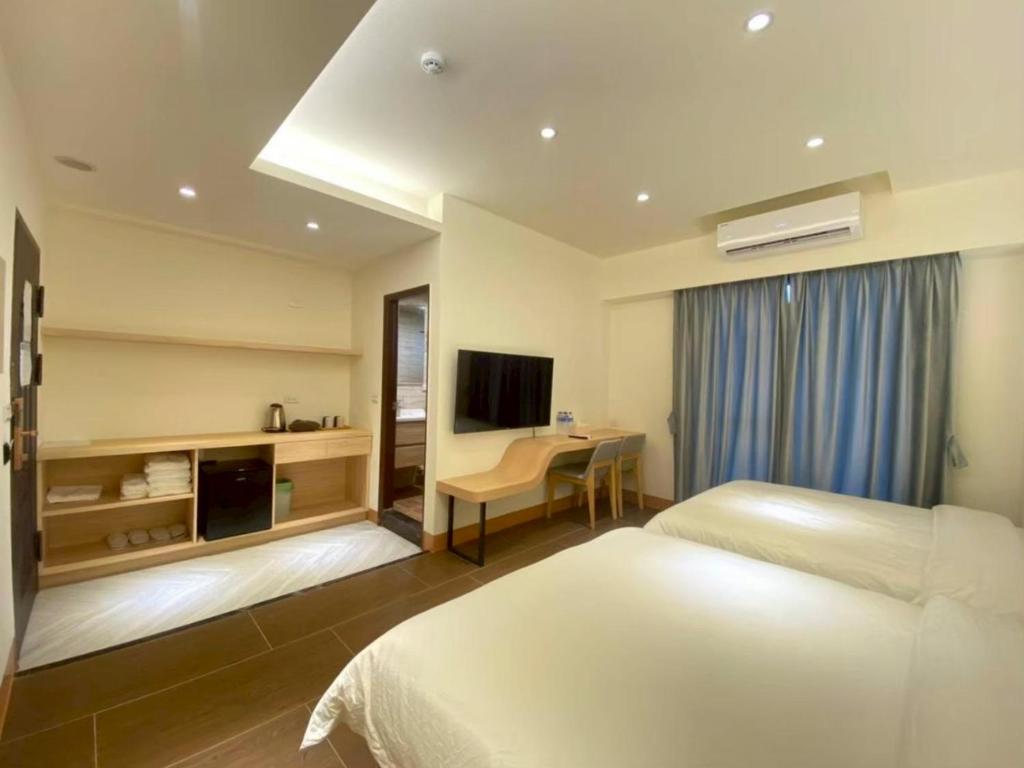 a hotel room with a bed and a desk at Yunfeng Hotel 雲峰精品文旅 in Jinning