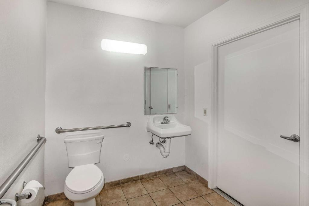 a bathroom with a toilet and a sink at Motel 6-Visalia, CA in Visalia