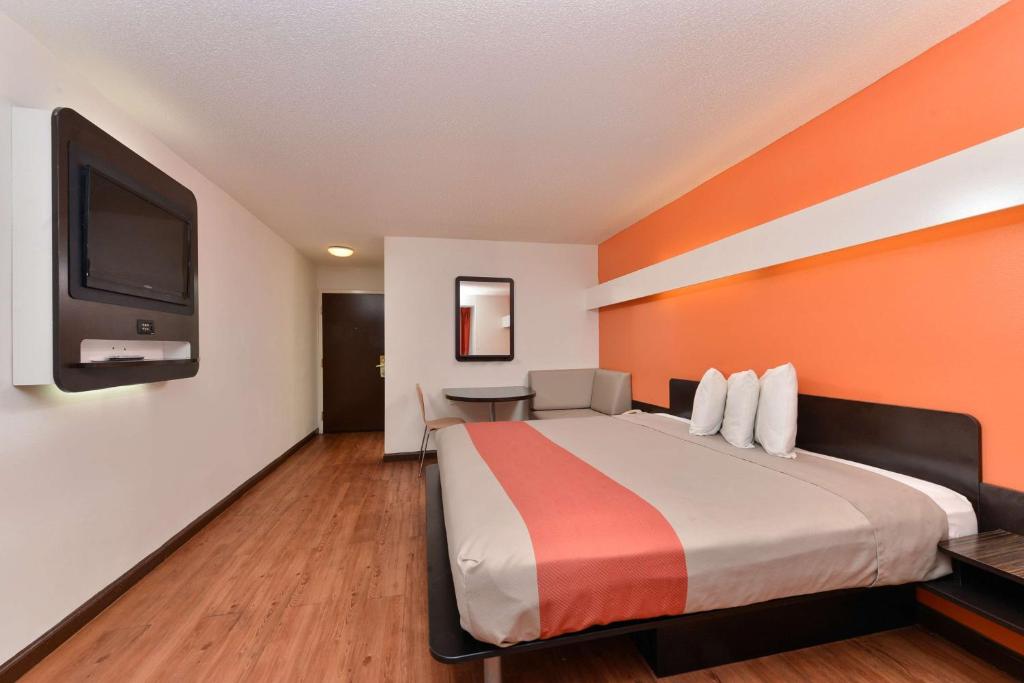 a hotel room with a bed and a flat screen tv at Motel 6-Richburg, SC in Richburg