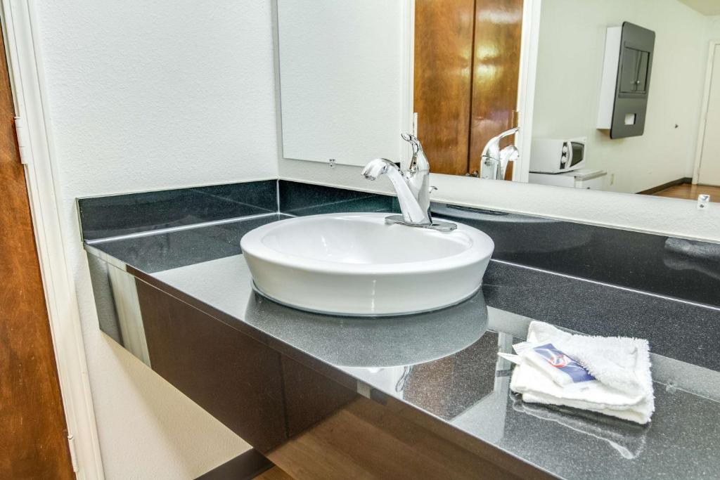 a bathroom with a sink and a mirror at Motel 6-Longview, TX - North in Longview