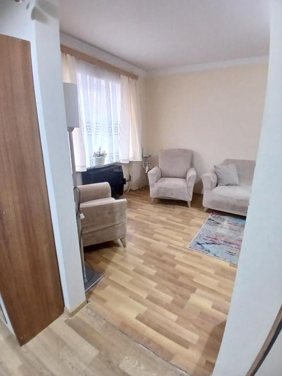 a living room with two chairs and a couch at уют in Rustavi