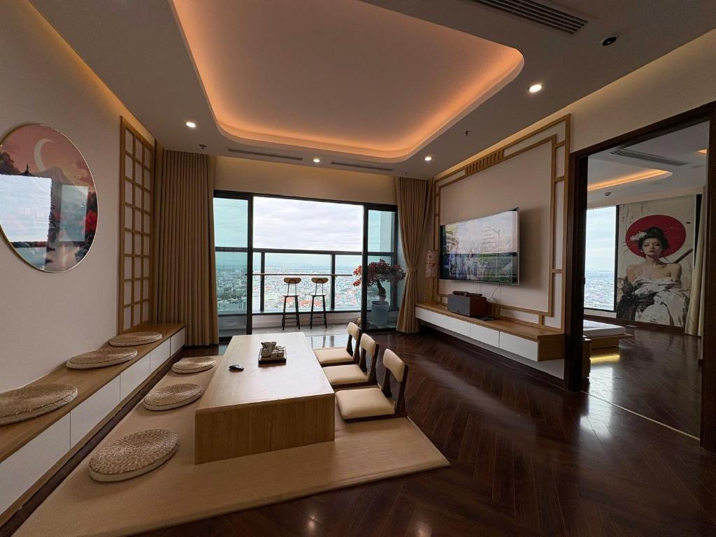 a dining room with a table and a view of the ocean at QNC Taiyo Homestay in Hai Phong