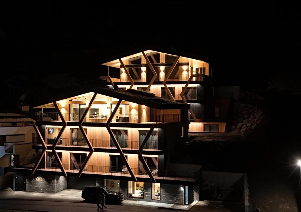 a building with a lit up facade at night at Aurum in Ischgl