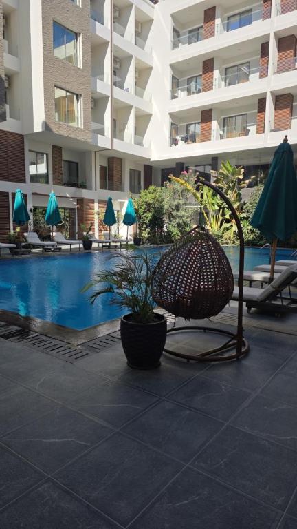 a patio with a chair and a pool in a building at 2 Bedroom Duplex - Hurghada in Hurghada