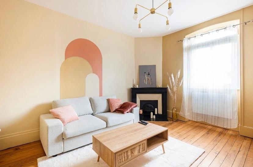 a living room with a couch and a coffee table at L'Authentique Free parking in Mâcon