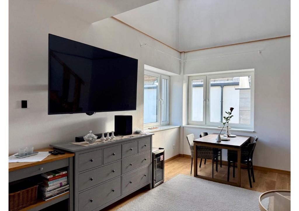 a living room with a large television on a wall at Atelier K7 in Žilina
